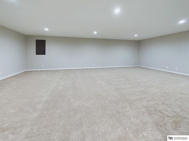 spare room featuring light colored carpet