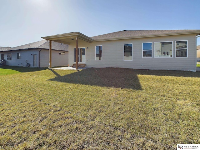 rear view of house featuring a lawn