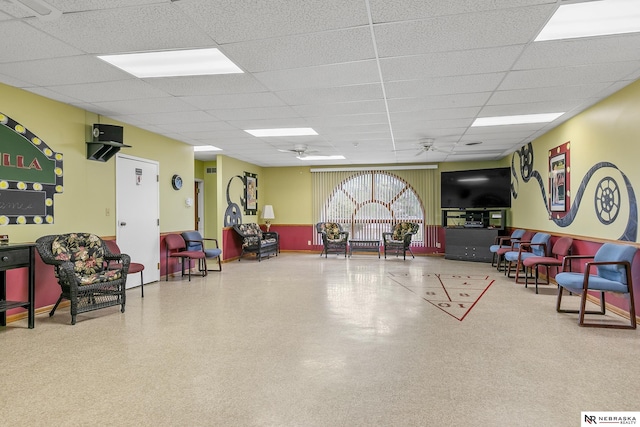 recreation room featuring a paneled ceiling and ceiling fan