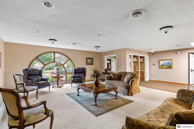 carpeted living room featuring a textured ceiling