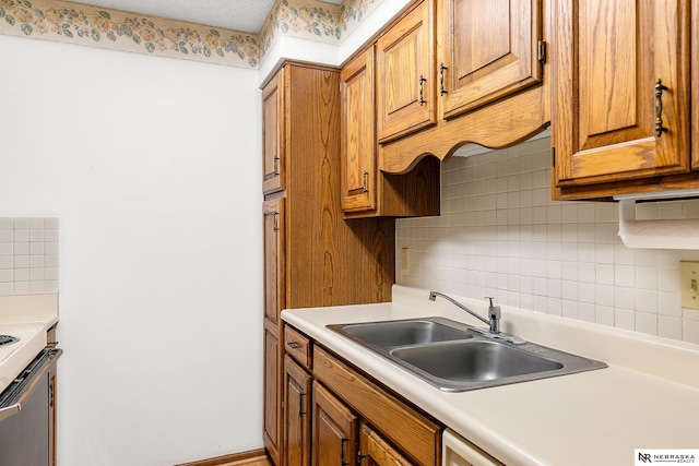 kitchen featuring range, tasteful backsplash, and sink