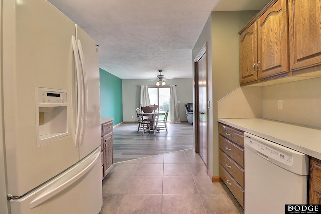 kitchen featuring ceiling fan, tile patterned flooring, and white appliances