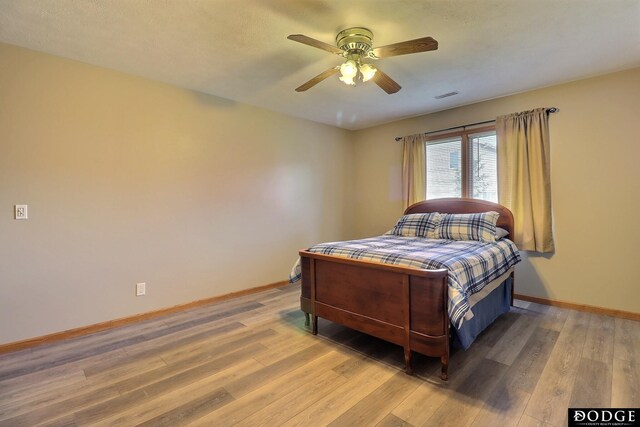 bedroom with hardwood / wood-style flooring and ceiling fan