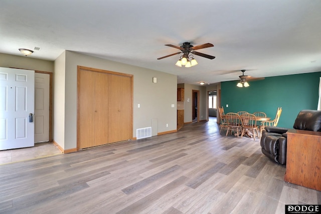 living room with ceiling fan and light hardwood / wood-style floors