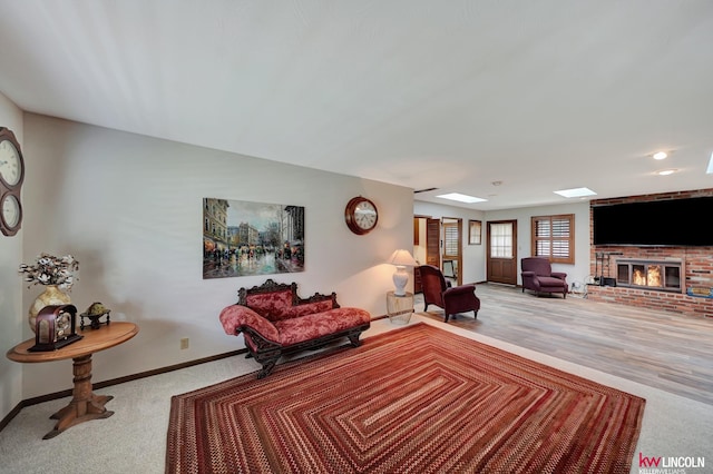 carpeted living room with a brick fireplace