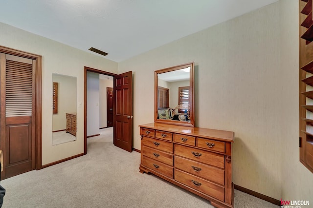 bedroom with a closet and light colored carpet