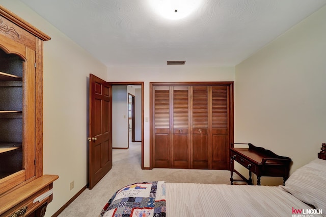 carpeted bedroom with a closet