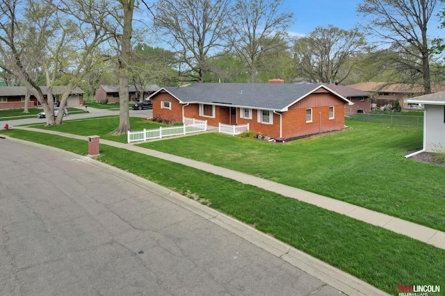 ranch-style home featuring a front yard