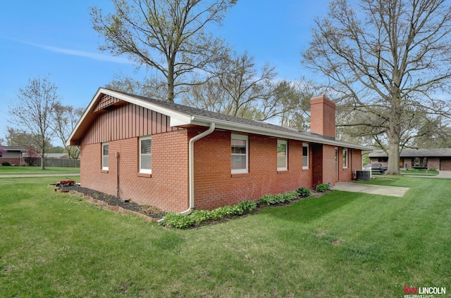 view of side of home featuring a yard