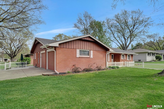 view of home's exterior with a garage and a lawn