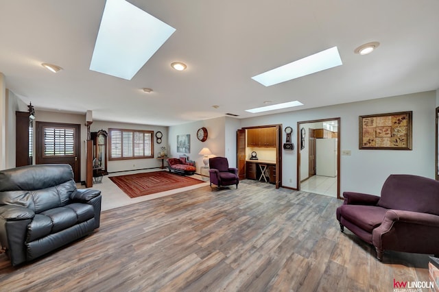 living room with a skylight and hardwood / wood-style floors