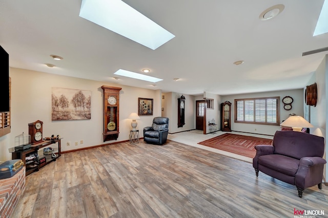 living room featuring hardwood / wood-style flooring and a skylight