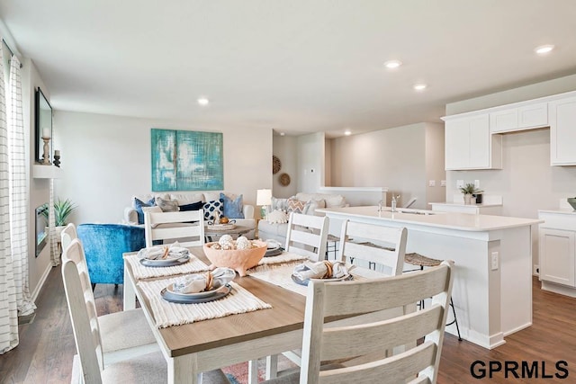 dining area featuring sink and dark hardwood / wood-style flooring