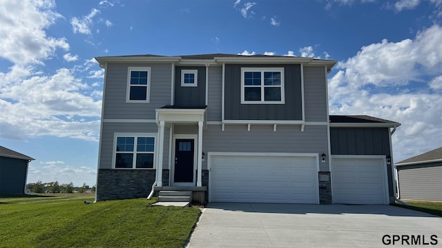 view of front of home featuring a garage and a front yard