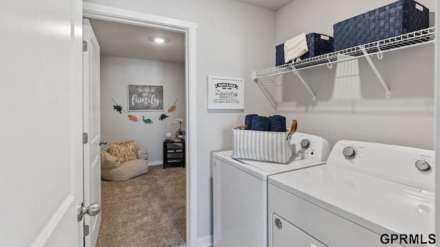 laundry area with washing machine and clothes dryer and carpet flooring