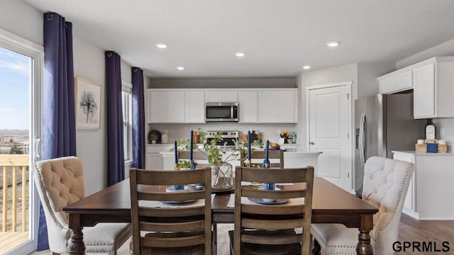 kitchen featuring white cabinetry, appliances with stainless steel finishes, and dark hardwood / wood-style flooring