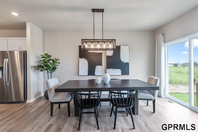 dining area with a healthy amount of sunlight and light wood-type flooring