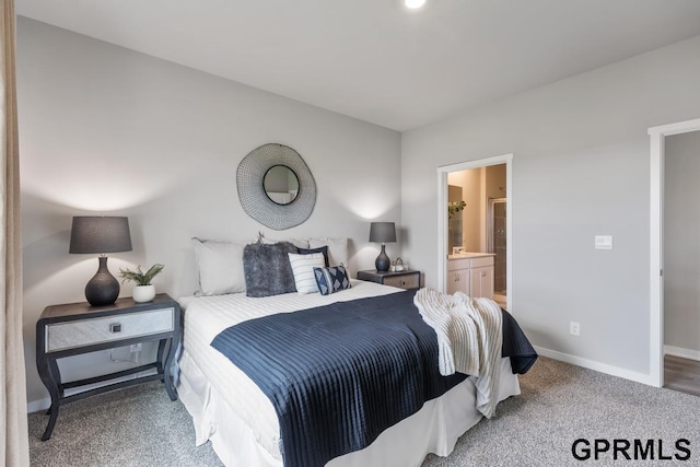 bedroom featuring connected bathroom and carpet