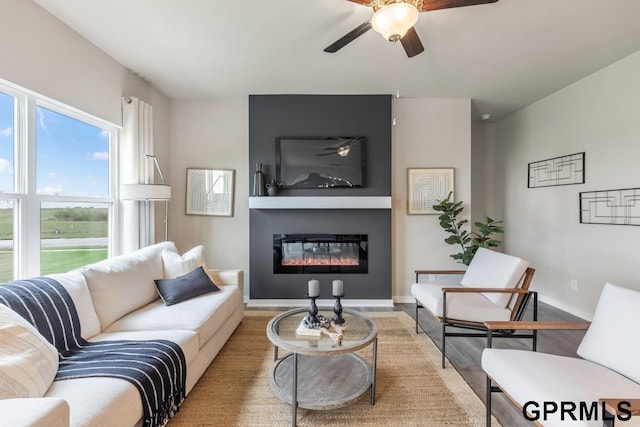 living room with ceiling fan and light wood-type flooring