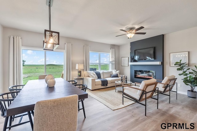 living room featuring light hardwood / wood-style flooring and ceiling fan