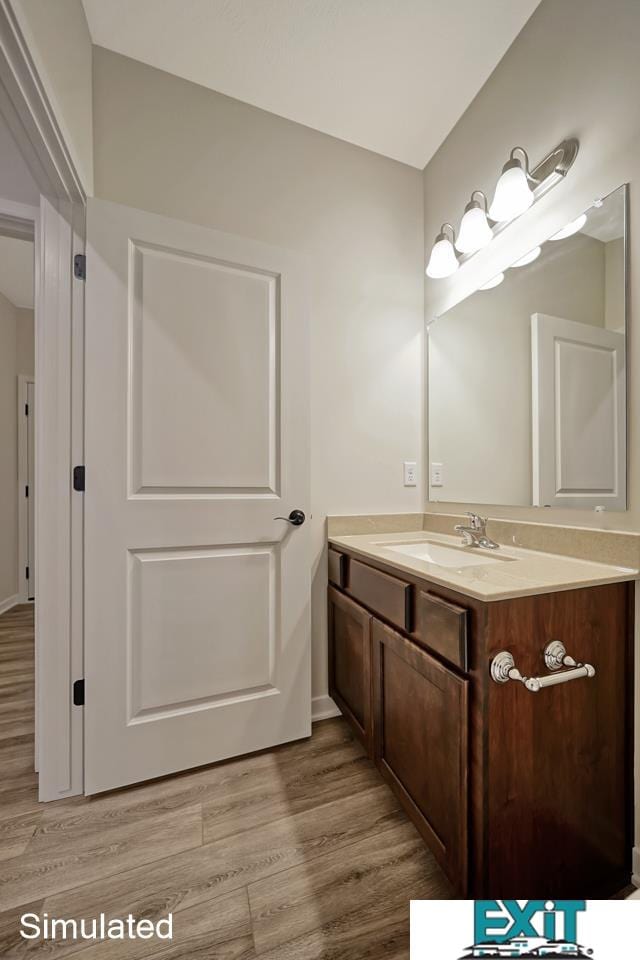 bathroom with wood-type flooring and vanity