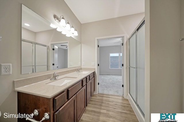 bathroom with vanity, wood-type flooring, and walk in shower