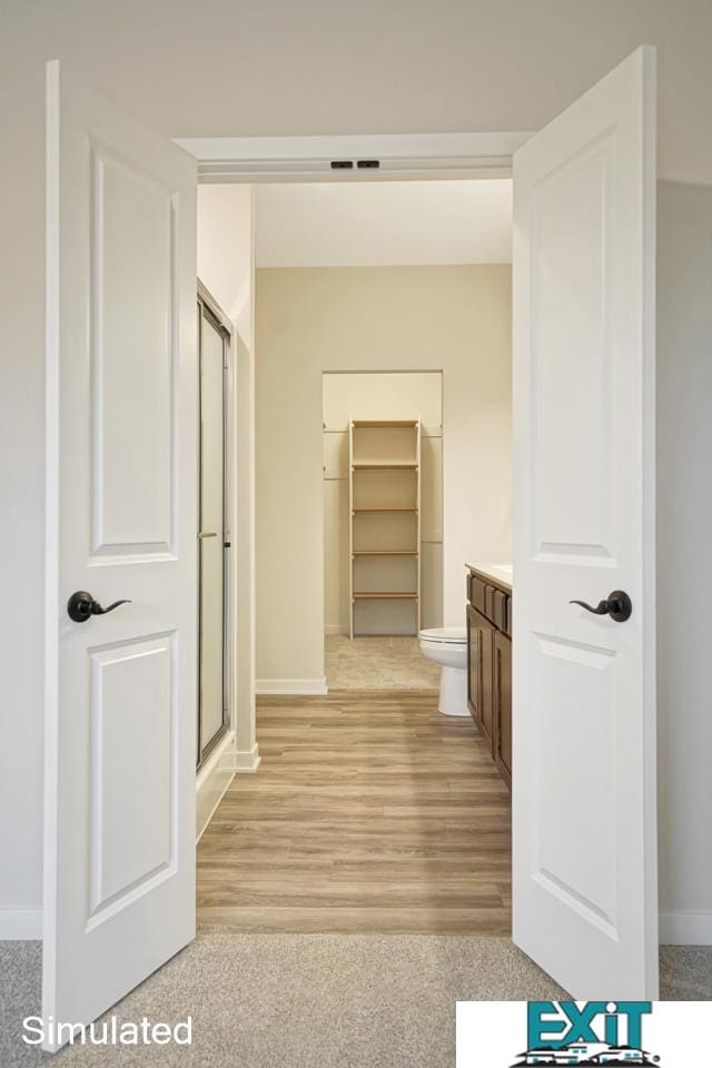 hall with light hardwood / wood-style floors