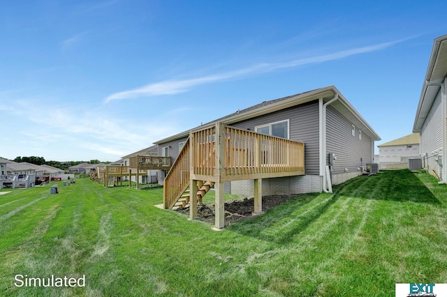 rear view of house with a wooden deck, a lawn, and central AC unit