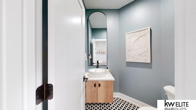 bathroom featuring vanity, toilet, and tile patterned floors