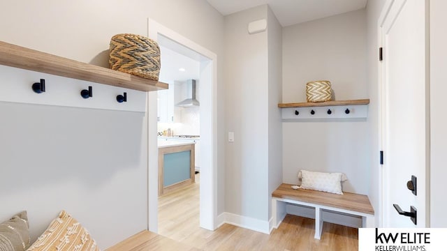 mudroom featuring baseboards and light wood-style floors