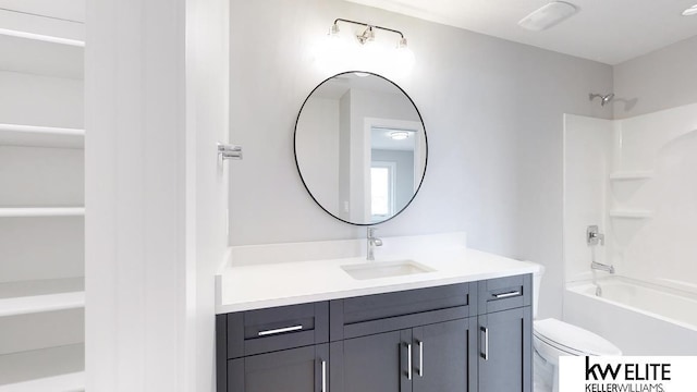 bathroom with washtub / shower combination, toilet, and vanity