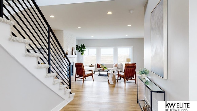 entrance foyer featuring light wood-style floors, recessed lighting, and stairs