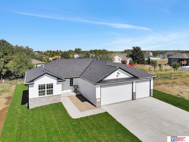 ranch-style home with a garage and a front lawn