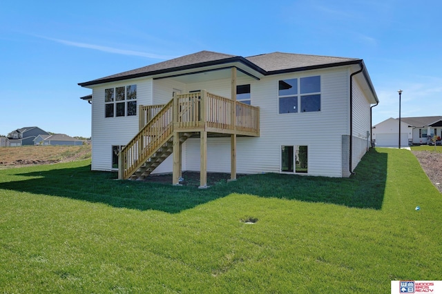 rear view of house featuring a lawn, a deck, and a garage