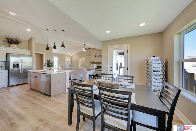 dining room featuring lofted ceiling, sink, ceiling fan, and a wealth of natural light