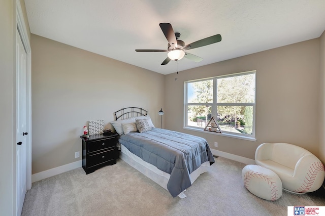 carpeted bedroom featuring ceiling fan and a closet