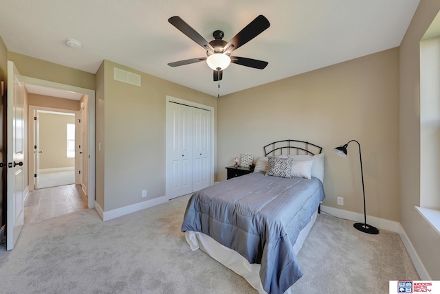 carpeted bedroom featuring a closet and ceiling fan