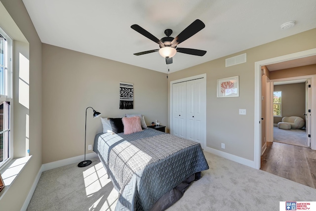 bedroom featuring light wood-type flooring, ceiling fan, and a closet