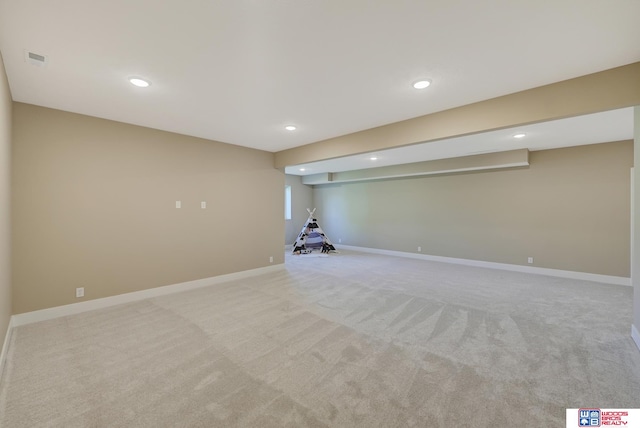 basement featuring light colored carpet