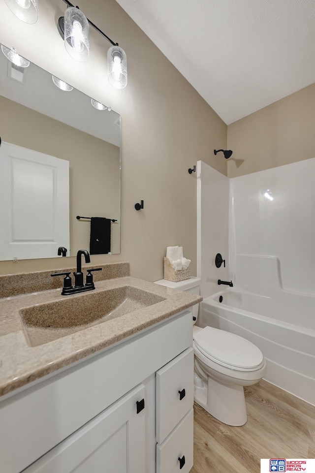 full bathroom featuring shower / tub combination, wood-type flooring, vanity, and toilet