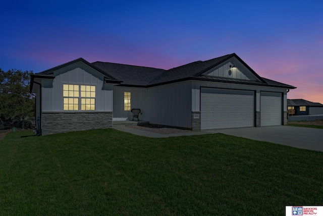 ranch-style house featuring a garage and a yard