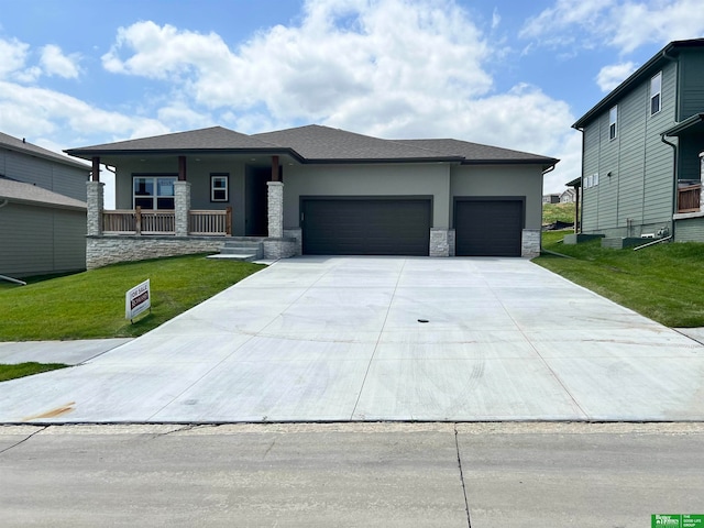 prairie-style home with a garage and a front yard