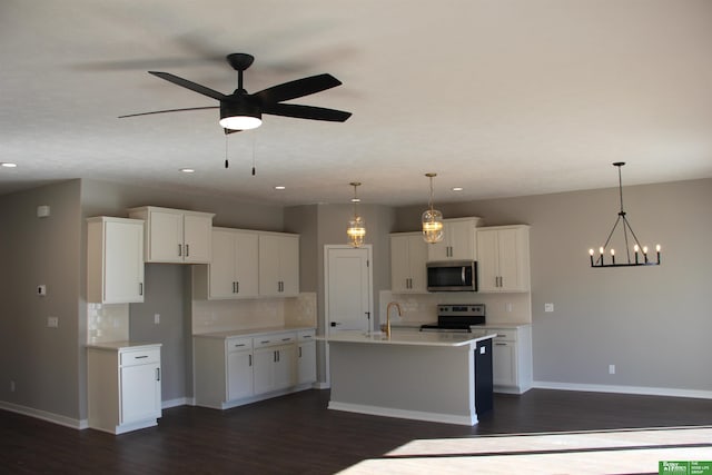 kitchen with white cabinets, stainless steel appliances, tasteful backsplash, and dark wood-type flooring