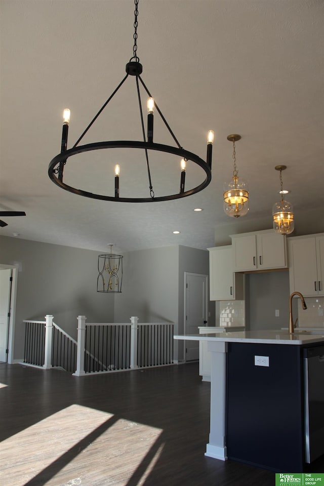 kitchen featuring a center island, decorative backsplash, hardwood / wood-style flooring, and decorative light fixtures