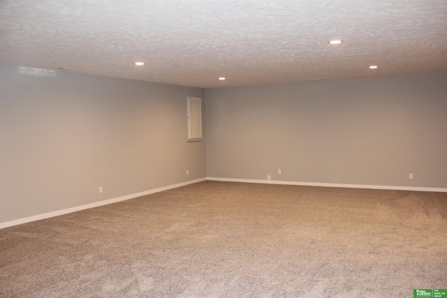 empty room with carpet flooring and a textured ceiling