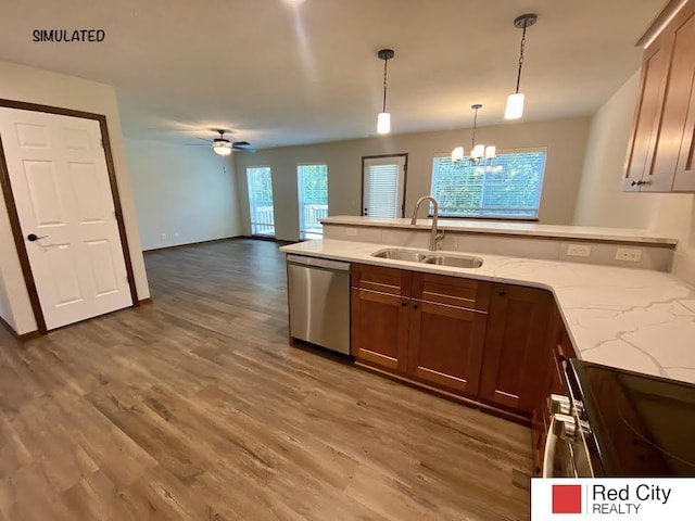 kitchen with sink, ceiling fan with notable chandelier, dishwasher, light stone counters, and decorative light fixtures