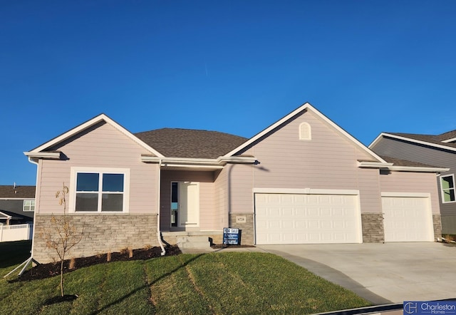 view of front of home with a garage and a front yard