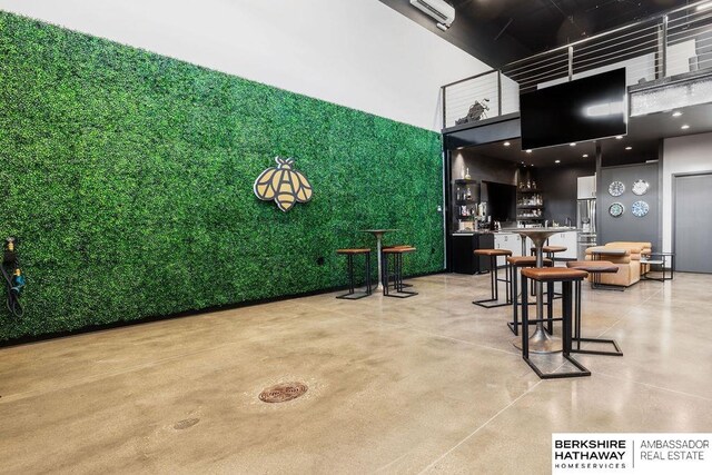 interior space with a high ceiling and bar area