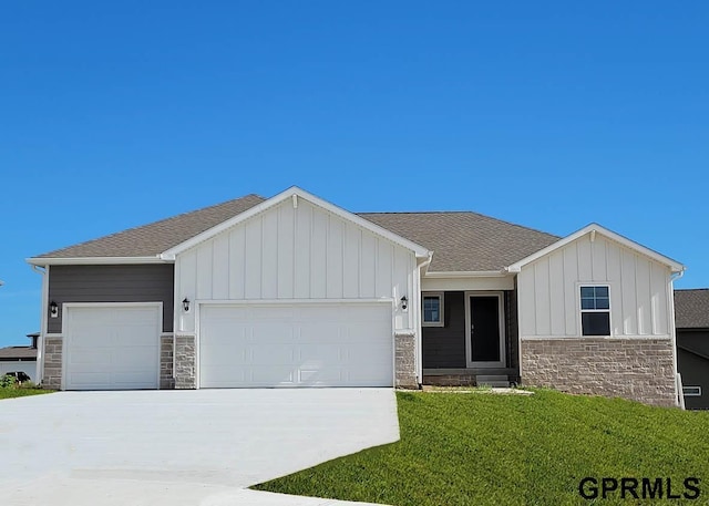 view of front of home with a garage and a front lawn