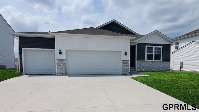 ranch-style home with an attached garage, stone siding, concrete driveway, and a front yard